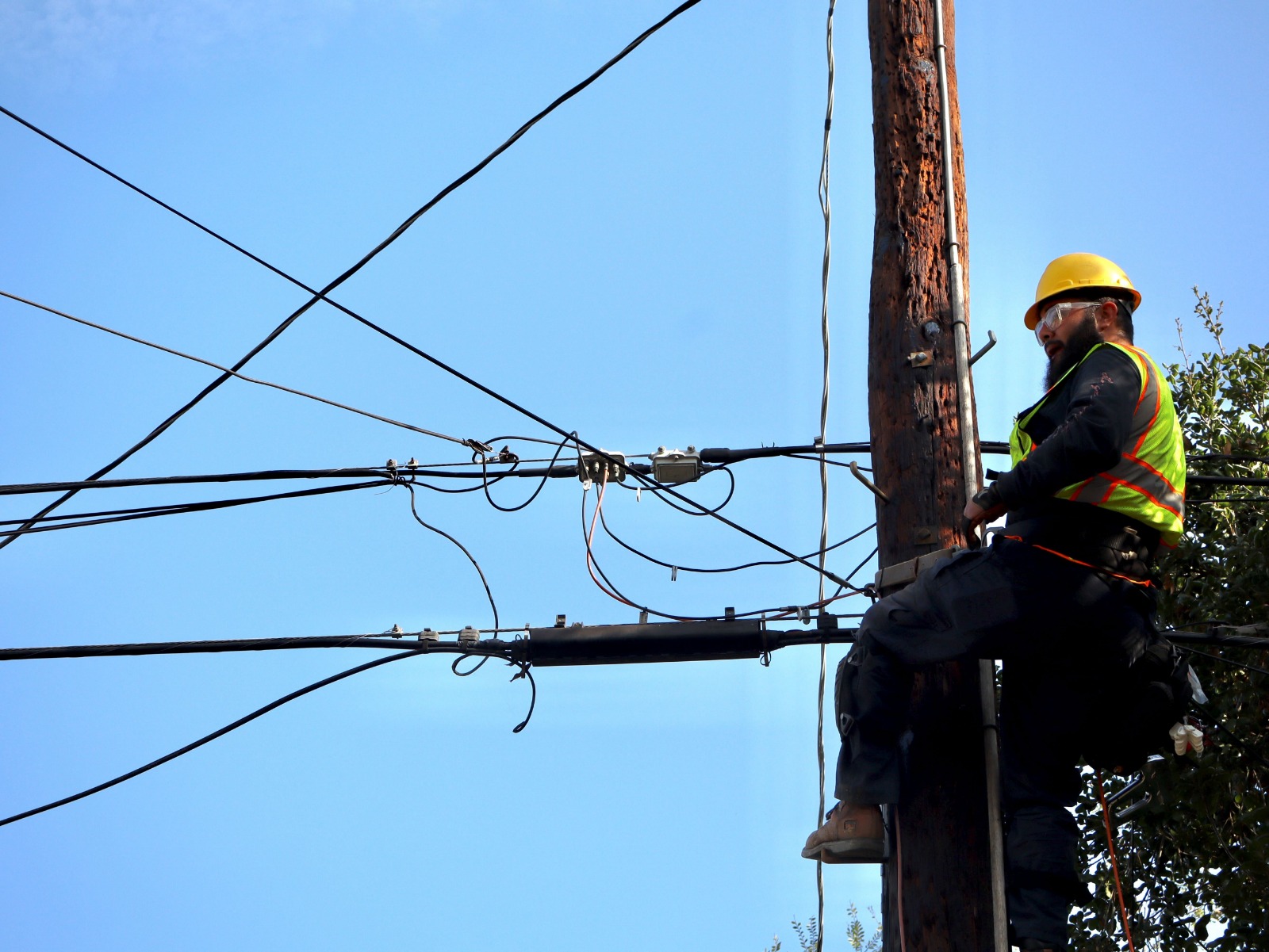 Technicians working on utility poles